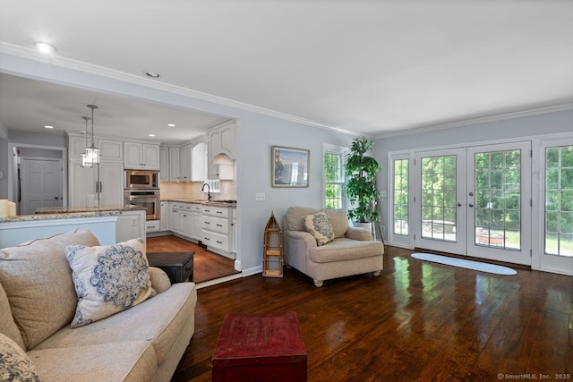 3 Colonial Dr, Clinton, CT 06413 - living area with dark wood finished floors, healthy amount of natural light, french doors, ornamental molding, and recessed lighting