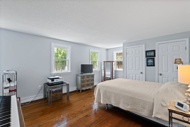 3 Colonial Dr, Clinton, CT 06413 - bedroom with wood-type flooring, a baseboard heating unit, and a baseboard radiator