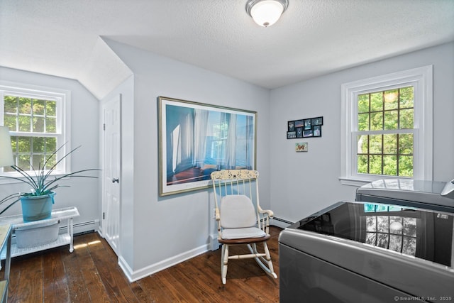 3 Colonial Dr, Clinton, CT 06413 - bedroom with dark wood-type flooring, multiple windows, washing machine and clothes dryer, a textured ceiling, and baseboard heating