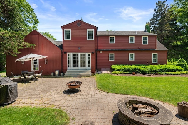 3 Colonial Dr, Clinton, CT 06413 - rear view of house featuring an outdoor fire pit, a patio, a yard, and a shingled roof