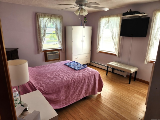 148 Millbrook Rd, Meriden, CT 06450 - bedroom with an AC wall unit, light wood finished floors, a ceiling fan, and baseboards