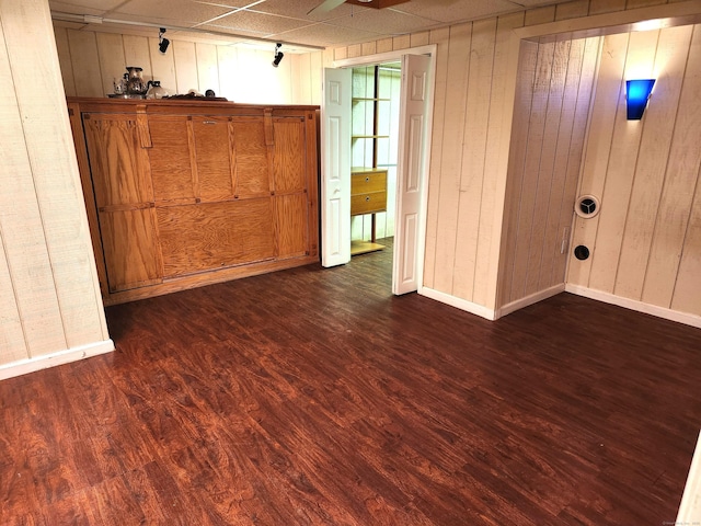 148 Millbrook Rd, Meriden, CT 06450 - empty room featuring dark wood-style floors, wood walls, and baseboards