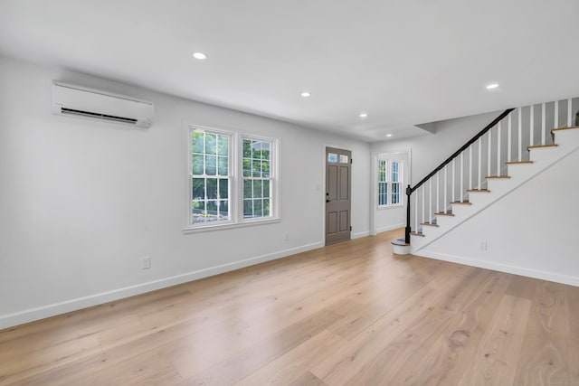 189 Tashua Rd, Trumbull, CT 06611 - foyer entrance with a wall mounted AC, stairs, recessed lighting, and light wood-type flooring