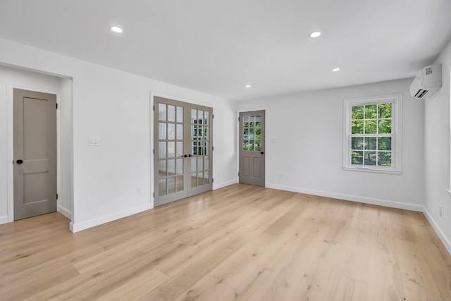 189 Tashua Rd, Trumbull, CT 06611 - empty room featuring french doors, an AC wall unit, light wood finished floors, and recessed lighting