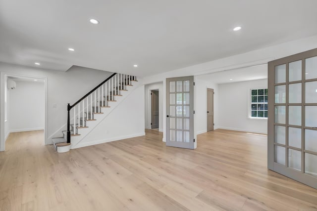 189 Tashua Rd, Trumbull, CT 06611 - unfurnished living room with stairway, french doors, light wood-style flooring, and recessed lighting