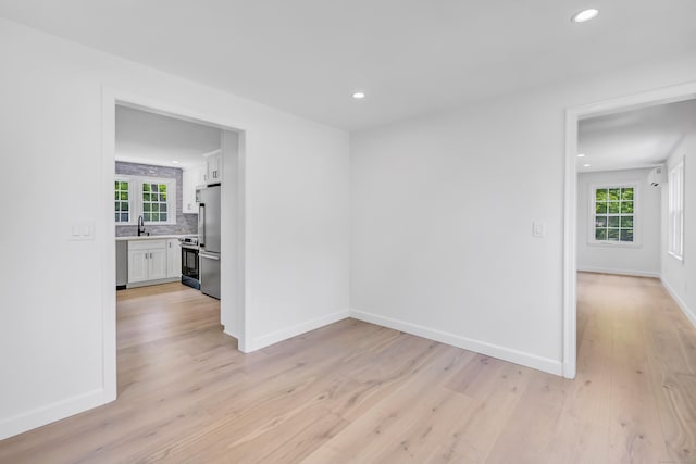 189 Tashua Rd, Trumbull, CT 06611 - empty room featuring light wood-style floors, recessed lighting, and plenty of natural light