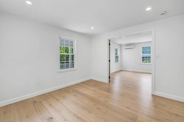 189 Tashua Rd, Trumbull, CT 06611 - unfurnished room featuring a wall mounted air conditioner, plenty of natural light, a smoke detector, recessed lighting, and light wood-style floors
