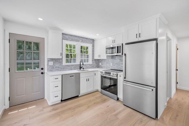 189 Tashua Rd, Trumbull, CT 06611 - kitchen featuring appliances with stainless steel finishes, white cabinetry, tasteful backsplash, and recessed lighting