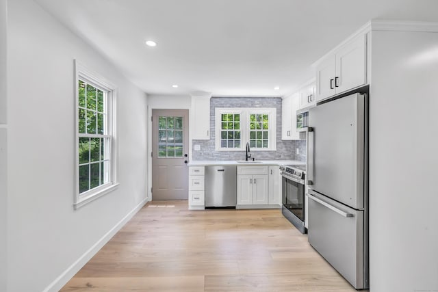 189 Tashua Rd, Trumbull, CT 06611 - kitchen featuring appliances with stainless steel finishes, plenty of natural light, white cabinets, backsplash, and recessed lighting