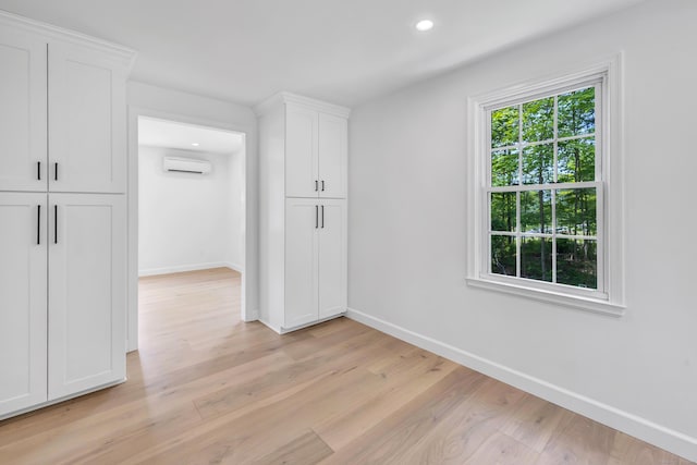 189 Tashua Rd, Trumbull, CT 06611 - spare room with a wall mounted AC, light wood-style floors, and recessed lighting