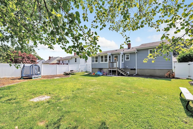 55 Osborne St, Stratford, CT 06614 - back of property with a trampoline, a fenced backyard, and a chimney