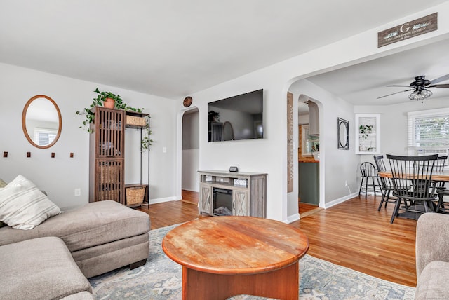 55 Osborne St, Stratford, CT 06614 - living area with arched walkways, a ceiling fan, and light wood-type flooring