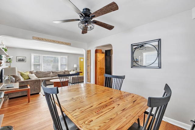 55 Osborne St, Stratford, CT 06614 - dining room featuring ceiling fan, arched walkways, and light wood-type flooring