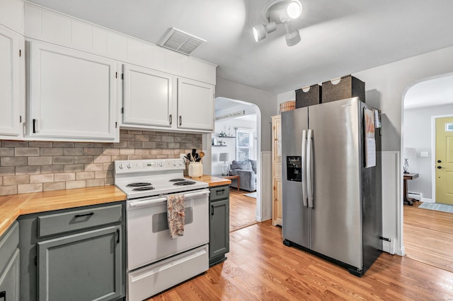 55 Osborne St, Stratford, CT 06614 - kitchen featuring white electric range oven, stainless steel fridge with ice dispenser, arched walkways, and light wood finished floors