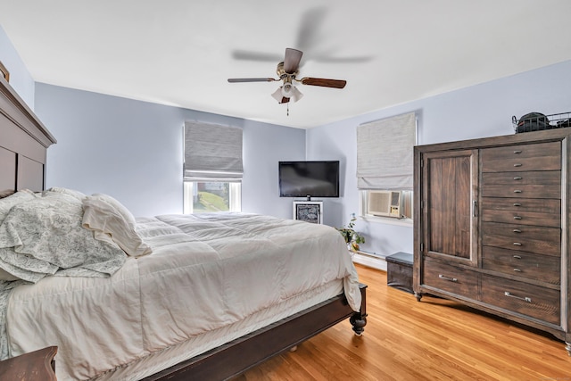 55 Osborne St, Stratford, CT 06614 - bedroom featuring light wood finished floors, cooling unit, a baseboard heating unit, and a ceiling fan