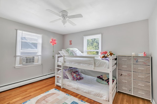 55 Osborne St, Stratford, CT 06614 - bedroom featuring baseboard heating, cooling unit, wood finished floors, and ceiling fan