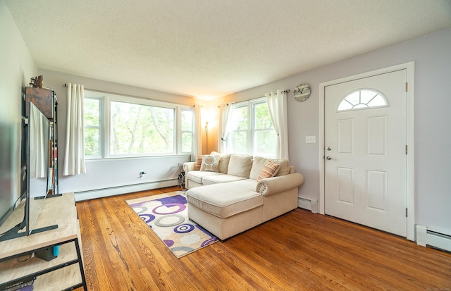 1 Trumbull St, Vernon, CT 06066 - living room featuring a baseboard radiator, baseboard heating, wood finished floors, and a textured ceiling
