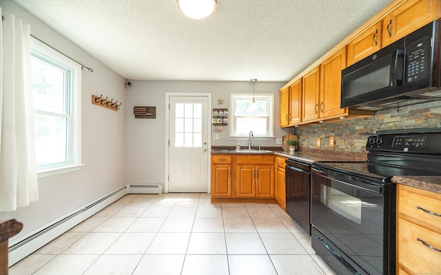 1 Trumbull St, Vernon, CT 06066 - kitchen with black appliances, a sink, a baseboard radiator, dark countertops, and backsplash