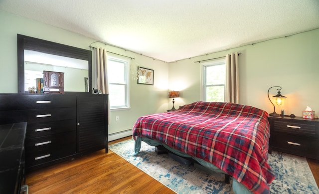 1 Trumbull St, Vernon, CT 06066 - bedroom featuring a baseboard radiator, wood finished floors, and a textured ceiling