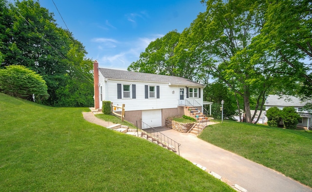 1 Trumbull St, Vernon, CT 06066 - single story home with concrete driveway, a garage, a chimney, a front yard, and stairway