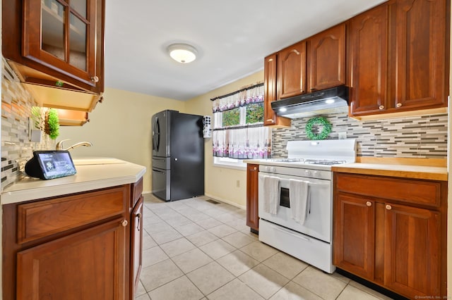 21 Sorrento Rd, Wallingford, CT 06492 - kitchen with freestanding refrigerator, white range with gas cooktop, under cabinet range hood, and light countertops