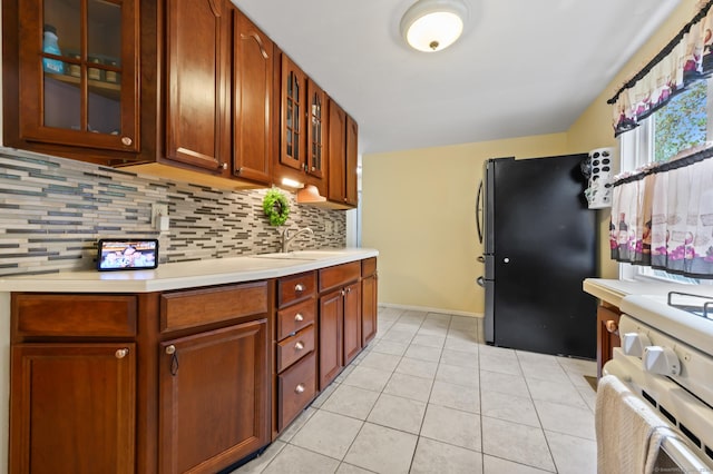 21 Sorrento Rd, Wallingford, CT 06492 - kitchen with freestanding refrigerator, light countertops, decorative backsplash, and glass insert cabinets