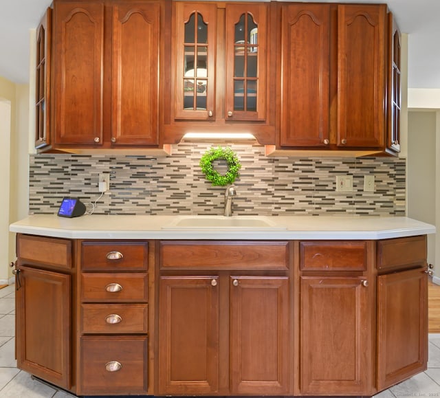 21 Sorrento Rd, Wallingford, CT 06492 - kitchen featuring a sink, light tile patterned floors, light countertops, and backsplash
