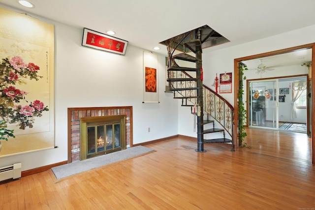 41 Alpine Rd, Monroe, CT 06468 - unfurnished living room featuring wood finished floors, stairway, baseboard heating, a fireplace, and recessed lighting