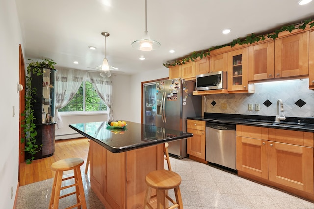 41 Alpine Rd, Monroe, CT 06468 - kitchen featuring stainless steel appliances, a sink, baseboard heating, a kitchen bar, and decorative backsplash