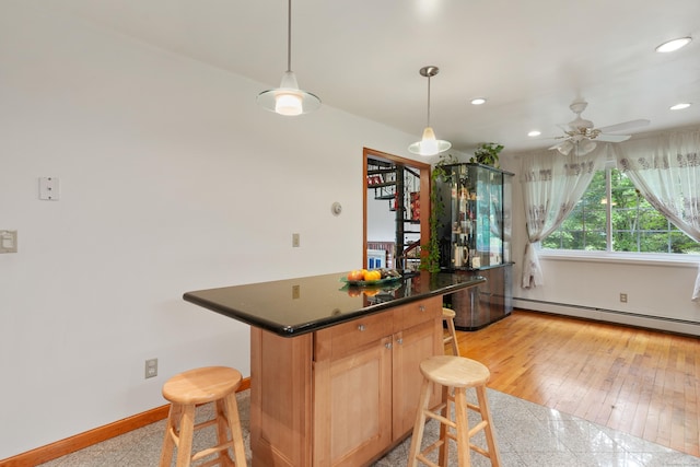 41 Alpine Rd, Monroe, CT 06468 - kitchen with a kitchen bar, baseboard heating, baseboards, recessed lighting, and dark countertops