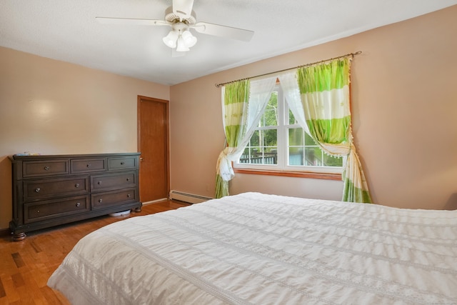 41 Alpine Rd, Monroe, CT 06468 - bedroom with a baseboard heating unit, wood finished floors, and ceiling fan