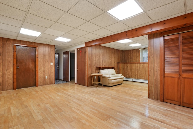 41 Alpine Rd, Monroe, CT 06468 - sitting room with a baseboard radiator, light wood-style floors, wooden walls, and a drop ceiling