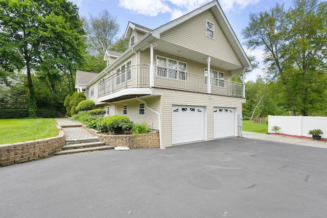 41 Alpine Rd, Monroe, CT 06468 - view of side of home with an attached garage, asphalt driveway, and a balcony
