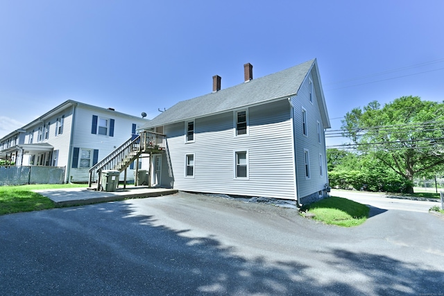 96 Water St, Killingly, CT 06239 - back of property featuring stairs and a chimney