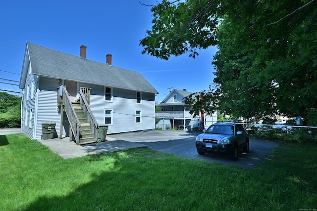 96 Water St, Killingly, CT 06239 - back of house featuring a chimney, stairs, and a shingled roof