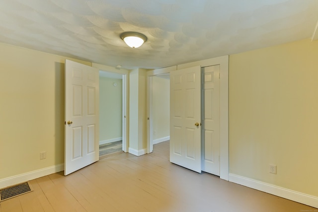 96 Water St, Killingly, CT 06239 - unfurnished bedroom featuring baseboards and light wood-style flooring