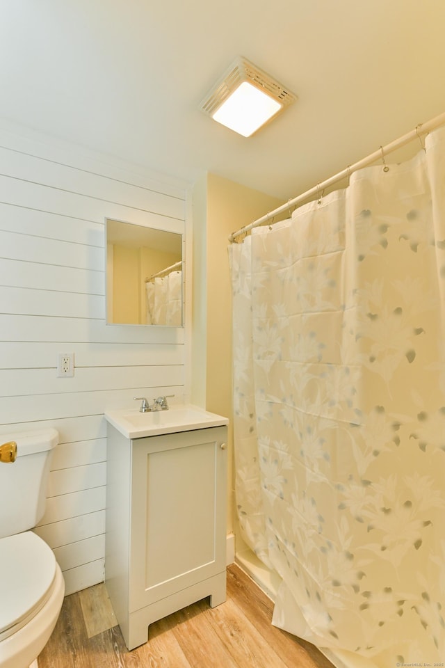 96 Water St, Killingly, CT 06239 - bathroom with wood finished floors, toilet, vanity, and curtained shower