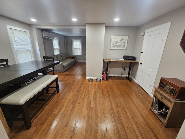 216 Bunker Hill Ave, Waterbury, CT 06708 - dining area with an AC wall unit, wood finished floors, recessed lighting, and baseboards