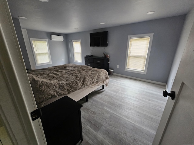 216 Bunker Hill Ave, Waterbury, CT 06708 - bedroom featuring an AC wall unit, wood finished floors, baseboards, and recessed lighting