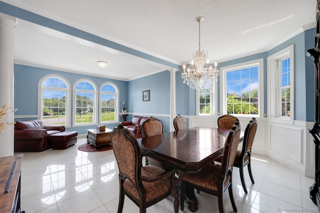 197 Shadow Pond Ln, Suffield, CT 06078 - dining area with ornamental molding, light tile patterned floors, a chandelier, and a wainscoted wall