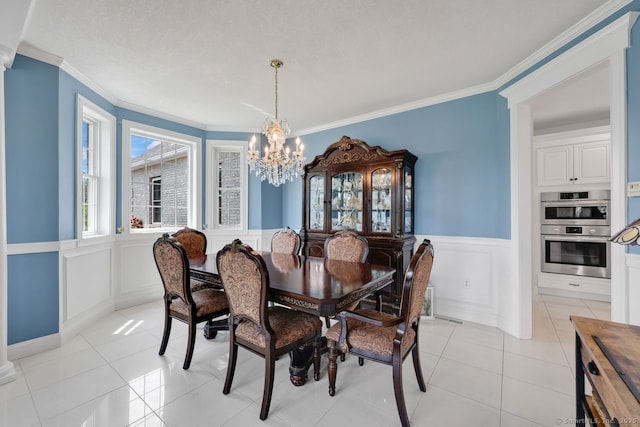 197 Shadow Pond Ln, Suffield, CT 06078 - dining room with a chandelier, a wainscoted wall, a decorative wall, ornamental molding, and light tile patterned flooring