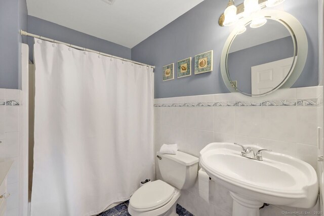 197 Shadow Pond Ln, Suffield, CT 06078 - full bathroom with tile walls, toilet, wainscoting, a chandelier, and a sink