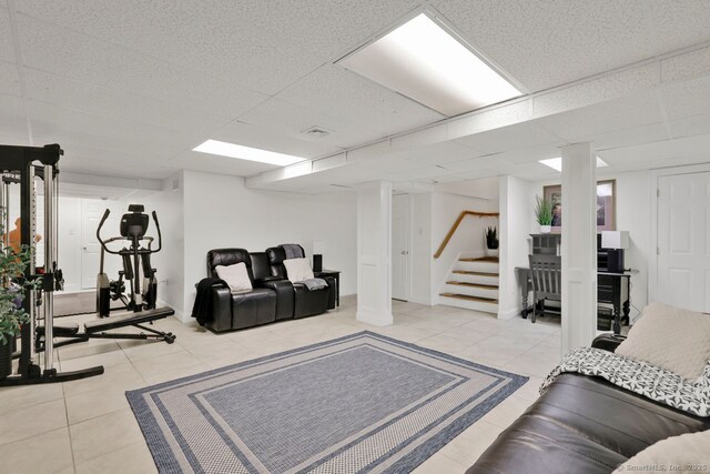 197 Shadow Pond Ln, Suffield, CT 06078 - living room featuring a drop ceiling, tile patterned flooring, and stairs