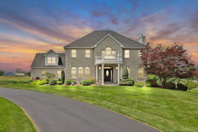 197 Shadow Pond Ln, Suffield, CT 06078 - colonial inspired home featuring a balcony, a chimney, a lawn, and a shingled roof