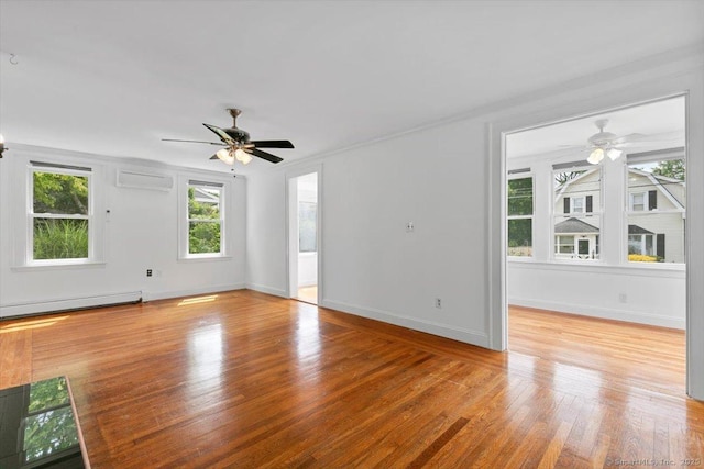 37 Park Ave, Hamden, CT 06517 - unfurnished living room featuring a ceiling fan, a wall mounted air conditioner, light wood-style flooring, and a baseboard radiator