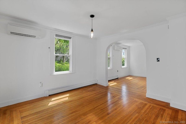 37 Park Ave, Hamden, CT 06517 - spare room with a wall mounted air conditioner, baseboard heating, arched walkways, ornamental molding, and baseboards