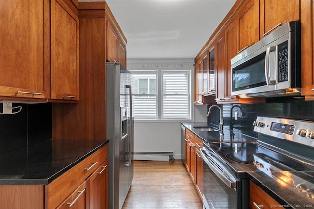 37 Park Ave, Hamden, CT 06517 - kitchen with appliances with stainless steel finishes, a sink, baseboard heating, brown cabinets, and tasteful backsplash