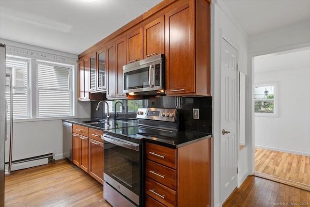 37 Park Ave, Hamden, CT 06517 - kitchen featuring appliances with stainless steel finishes, baseboard heating, a sink, light wood-type flooring, and brown cabinets
