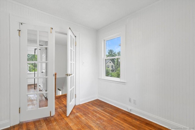 37 Park Ave, Hamden, CT 06517 - empty room with crown molding, wood finished floors, baseboards, and french doors