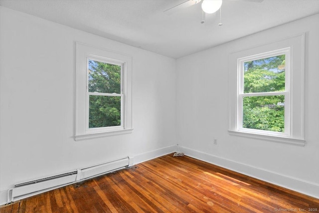 37 Park Ave, Hamden, CT 06517 - empty room featuring baseboard heating, healthy amount of natural light, wood finished floors, and baseboards